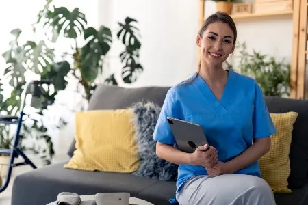 nurse using a tablet in home health setting